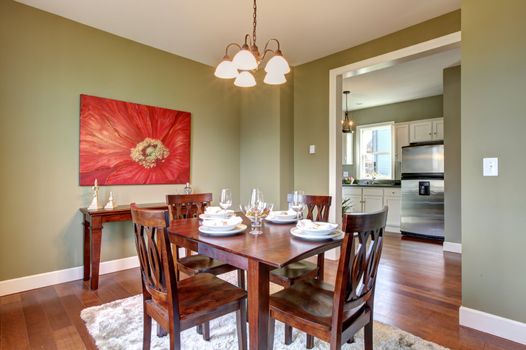 Beautiful green dining room with kitchen view.