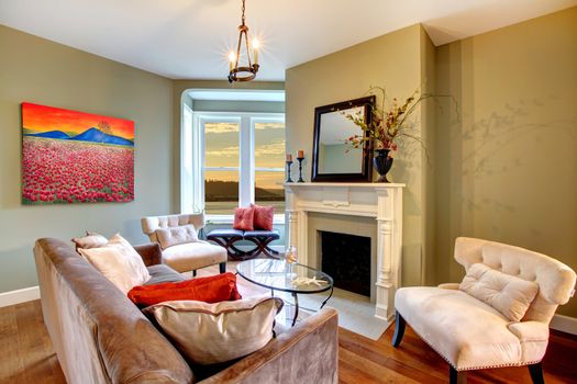 Living room with green walls and brown sofa.