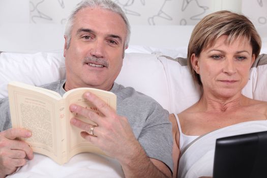 Couple reading in bed