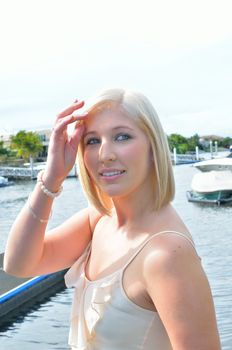 Attractive young lady in the sunshine at a boating marina