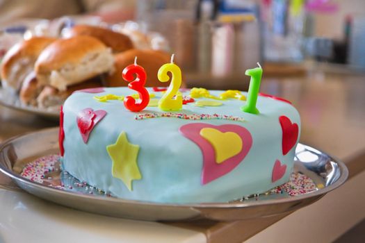 Homemade decorated partycake on plate for celebration of baby's first birthday