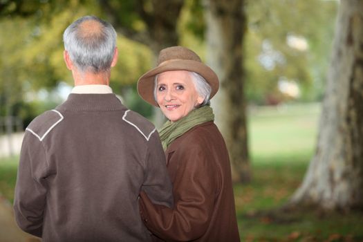 senior couple walking in the park