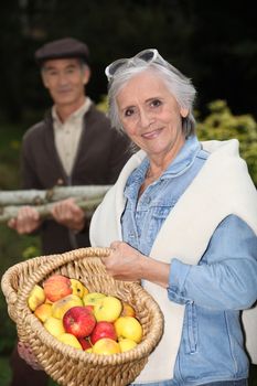 Couple with basket of apples