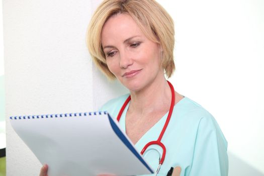 Nurse looking at chart