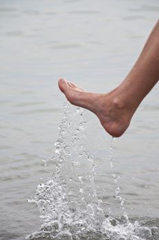 Women's leg with a spray of water