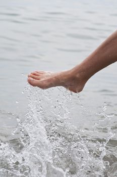 Women's leg with a spray of water