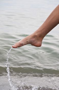 Women's leg with a spray of water