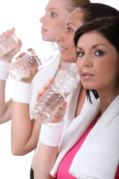 women training and drinking water