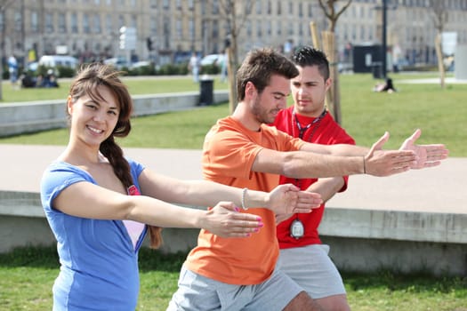 people doing stretching in a park