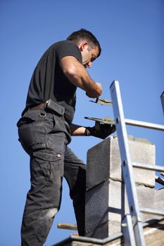 Roofer making a chimney stack