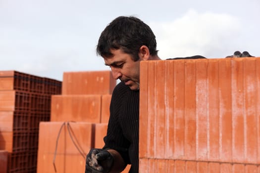 Housebuilder surrounded by large bricks