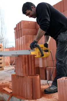 A workman using a chainsaw