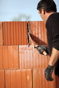 Mason cementing between bricks