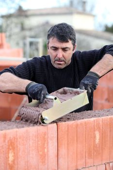 Bricklayer building a house