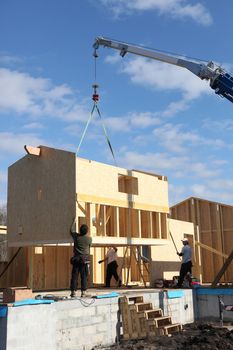 craftsmen building wooden house