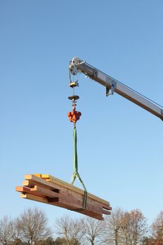 Crane lifting timber
