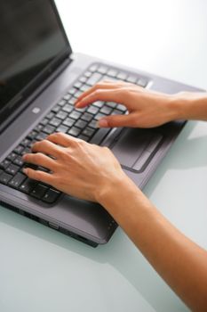 Close-up of woman typing on keyboard