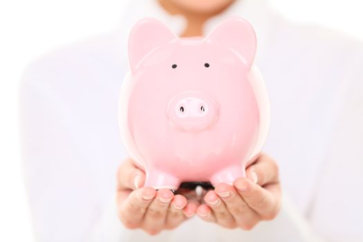 Piggy bank. Woman holding piggybank on white background. Money saving concept.