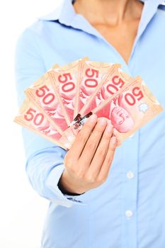 Canadian money dollars bills. 50 dollar bank note from Canada. The new plastic version from 2012. Woman holding Canadian money in hands.