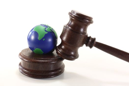 brown judges Gavel with colored globe on a light background