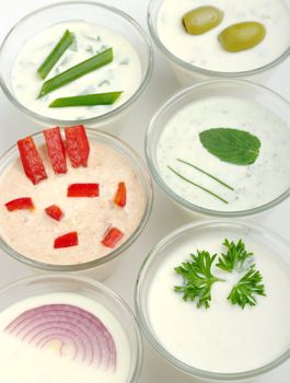 Various Cream Chees Spreads in small glass bowls (Selective Focus)