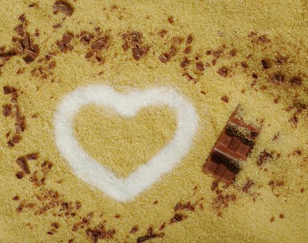 White Sugar in Heart Shape on Brown Sugar with Chocolate Bar
