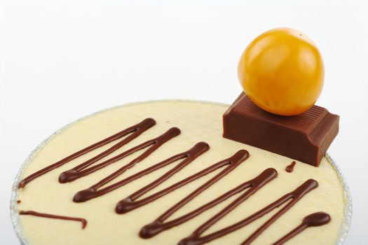 Small cake garnished with physalis berry and a piece of chocolate (Selective Focus)
