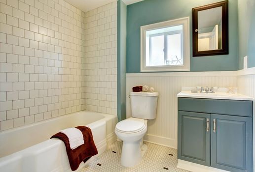 Classic simple blue bathroom with white tile.