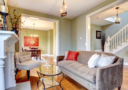 Green interior with cherry wood floor and nice furniture.