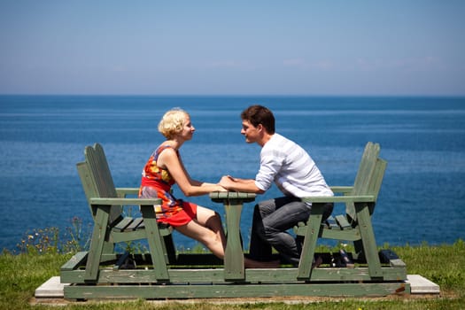 Romantic couple looking each other on the bench