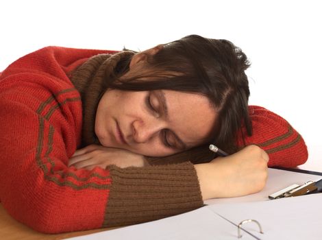 Young Caucasian woman fell asleep while writing and studying. Isolated on white (Selective Focus, Focus on the face)