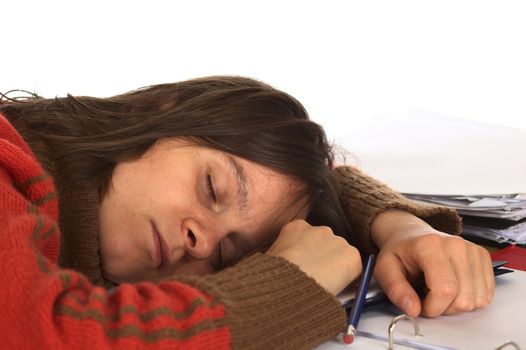 Young Caucasian woman fell asleep while writing and studying. Isolated on white (Selective Focus, Focus on the right eye and the right side of the face)