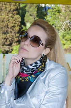 Beautiful young woman in cafe in sunny day