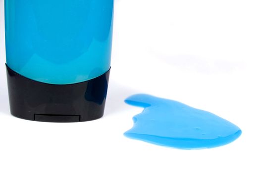 blue colored shower gel bottle and squeezed sample isolated on white