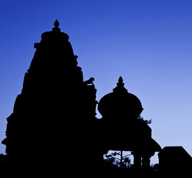 Rajasthan, India, silhouette of Jain and Hindu temples side by side as the night falls