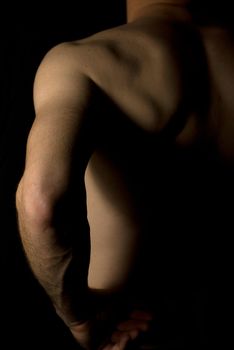 sexy fit naked male body on black background low key