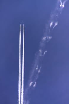 Condensation trail from a jet airplane with four engines