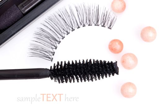 black false eyelashes with mascara and powder, on white background