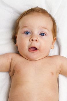 portrait of a baby in a white sheet