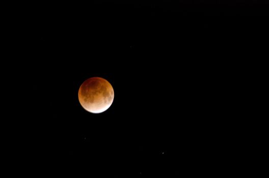 Red moon during a lunar eclipse on a black sky