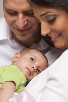 Happy Young Attractive Mixed Race Family with Newborn Baby.