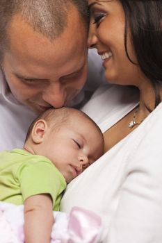 Happy Young Attractive Mixed Race Family with Newborn Baby.