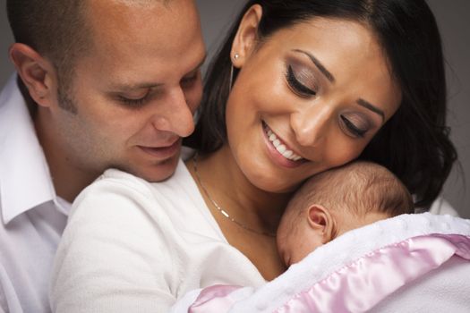 Happy Young Attractive Mixed Race Family with Newborn Baby.