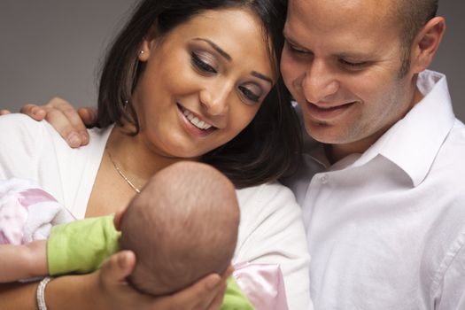 Happy Young Attractive Mixed Race Family with Newborn Baby.