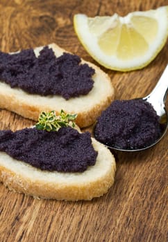 caviar canape on wood background