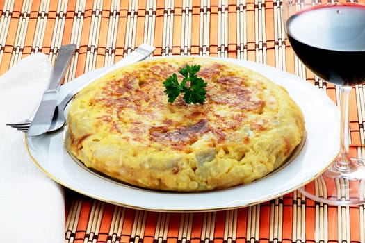 spanish omelet of potatoes and onion with a glass of red wine
