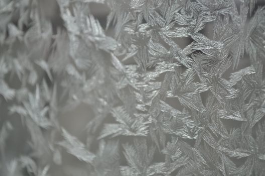 Frozen glass of a window in hard winter