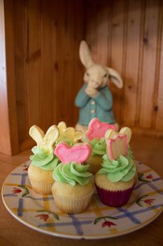 The Easter Bunny watches over cupcakes.