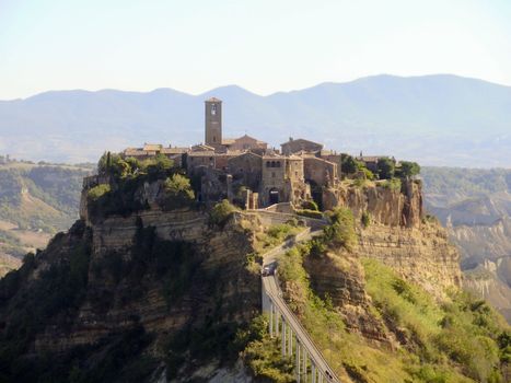The Italian hill town of Civita di Bagnoregio rests quietly on a hilltop created by earthquake and erosion.