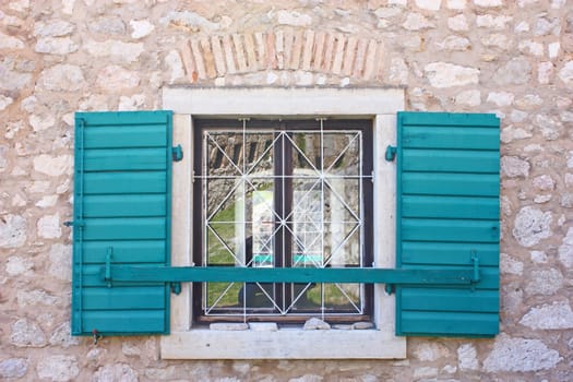 Open green wooden window shutters, security element